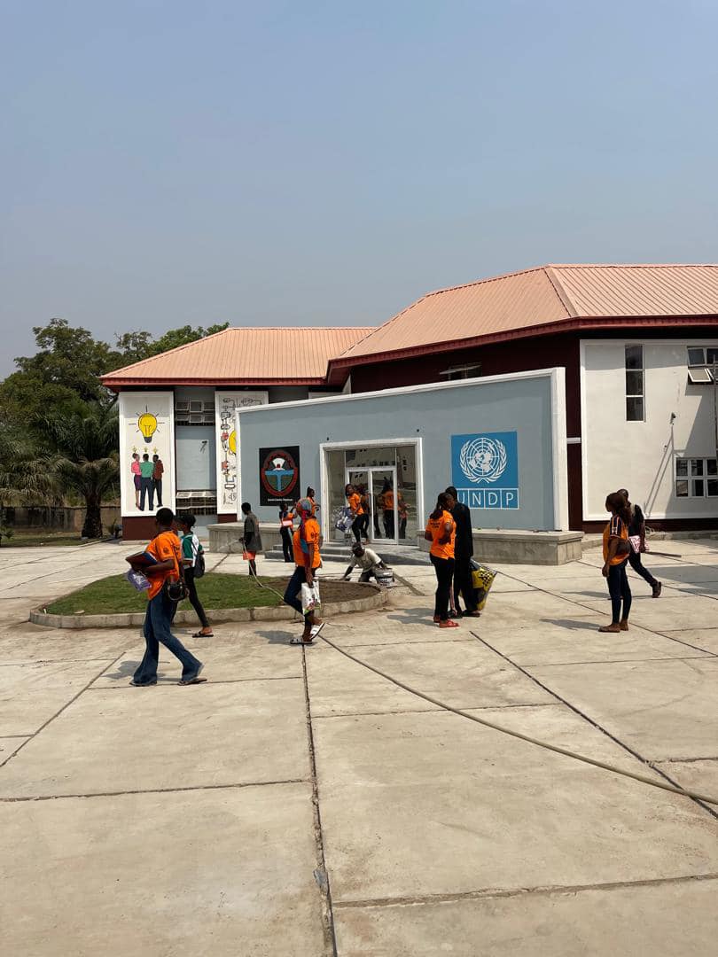 The UniPod MOAUM building, with UNDP branding, as students arrive at the hub